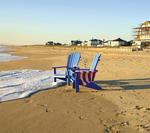 Amish Blue Poly Adirondack Chair at the beach with ice cold drinks in the cup holders