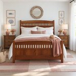 Front room view of a Mission panel bed with arched slatted ends, in a white coastal bedroom with a round driftwood mirror.