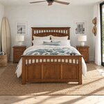 Front room view of a Mission panel bed with slats over arched panels, in a white beach bedroom with a surfboard.