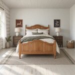Front room view of a traditional panel bed with an arched three-panel footboard, in a white log cabin bedroom.