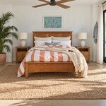 Front room view of a Shaker panel bed with a flat-top panel headboard, in a white beach bedroom with a ceiling fan.