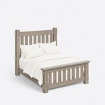 High angled view of a rustic slat bed, looking down on the tall slatted headboard, plain side rails and capped footboard.