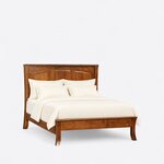 Diagonal angled view showing the right side of a Shaker panel bed, with a three-panel headboard and flared saber legs.