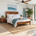 Diagonal angled room view showing the right side of a Shaker panel bed with flared legs, in a sunny beach house bedroom.