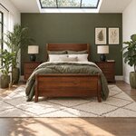 Front room view of a traditional sleigh bed with a rolled headboard, in an olive-green bedroom with a skylight.