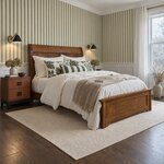 Diagonal angled room view showing the right side of a transitional panel bed with a low footboard, in a striped bedroom.