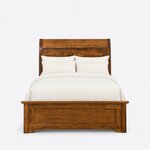 Front view of a transitional panel bed, showing a curved headboard with arched lower panels and a low capped footboard.