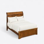 High angled view of a transitional panel bed, looking down on the curved headboard, plain side rails and capped footboard.