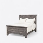 Diagonal angled view showing the left side of a rustic panel bed, with a planked headboard and a matching footboard.