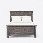 Front view of a rustic panel bed, showing a tall plank headboard and a lower plank footboard with an arched bottom rail.