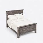 High angled view of a rustic panel bed, looking down on the plank headboard, deep side rails and arched plank footboard.