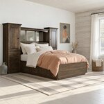 Diagonal angled room view showing the right side of a wall unit storage bed with side drawers, in a log cabin bedroom.