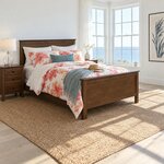 Diagonal angled room view showing the right side of a transitional panel bed with a panel footboard, in a coastal bedroom.