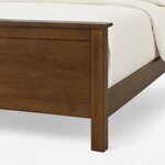 Footboard close-up of a transitional panel bed, showing the eased cap rail, a square corner leg and a flat recessed panel.