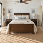Front room view of a transitional panel bed with a flat-panel headboard, in a white beach house bedroom with a surfboard.