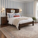 Diagonal angled room view showing the right side of a Shaker bookcase bed with a center mirror, in a blue-striped bedroom.