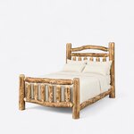 Diagonal angled view showing the left side of a rustic log bed, with an arched branch headboard and a picket footboard.