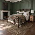 Diagonal angled room view showing the left side of a rustic log bed with a spindle footboard, in a green-paneled bedroom.