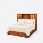Diagonal angled view showing the left side of a rustic bookcase bed, with a cabinet and cubby headboard and log posts.