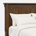 Headboard close-up of a Mission panel bed, showing recessed flat panels, a stepped corbel and the overhanging cap rail.