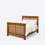 Diagonal angled view showing the left side of a Mission slat bed, with a slatted headboard and a high slatted footboard.