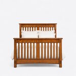Front view of a Mission slat bed, showing a tall slatted headboard behind a high footboard, each with a wide center slat.