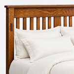 Headboard close-up of a Mission slat bed, showing flat slats under a broad top rail, the cap rail and an exposed tenon.