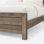 Footboard close-up of a contemporary panel bed, showing a mitered frame corner, recessed horizontal panels and a square leg.