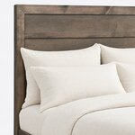 Headboard close-up of a contemporary panel bed, showing a mitered frame around flat horizontal panels and a divider rail.