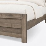 Footboard close-up of a contemporary bookcase bed, showing the mitered corner, recessed horizontal panels and a square leg.