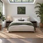 Front room view of a contemporary upholstered bed with a plain headboard and a low footboard, in a bedroom with a skylight.
