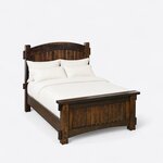 High angled view of a Mission panel bed, looking down on the arched headboard, plain side rails and capped plank footboard.