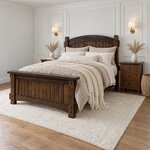 Diagonal angled room view showing the left side of a Mission panel bed with a capped footboard, in a white-paneled bedroom.