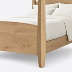 Footboard close-up of a classic pencil post bed, showing the arched footboard top and a faceted post tapering to the foot.