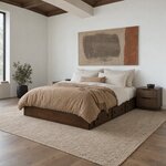 Diagonal angled room view showing the left side of a minimalist platform bed with side drawers, in a white beamed bedroom.