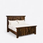 Diagonal angled view showing the right side of a rustic panel bed, with a barn-door plank headboard and a star footboard.