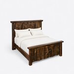 High angled view of a rustic panel bed, looking down on the barn-door headboard, the plain side rails and the star footboard.