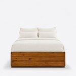 Front view of a minimalist platform bed, showing a low solid footboard above a recessed plinth and no headboard.