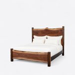 Diagonal angled view showing the left side of a live edge panel bed, with a slab headboard, a low footboard and block posts.