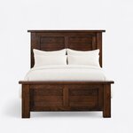 Front view of a rustic panel bed, showing a tall plank-filled two-panel headboard and a two-panel footboard on block legs.