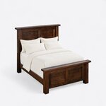 High angled view of a rustic panel bed, looking down on the capped headboard, straight side rails and two-panel footboard.