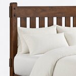 Headboard close-up of a Mission slat bed, showing flat slats under a wide top rail and a pegged post with a chamfered top.