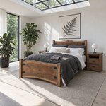 Diagonal angled room view showing the left side of a live edge panel bed with a slab footboard, in a skylit white bedroom.