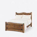 Diagonal angled view showing the left side of a live edge panel bed, with metal-strapped slabs between square posts.