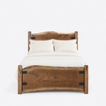 Front view of a live edge panel bed, showing a crowned slab headboard and a wavy slab footboard with an arched lower edge.