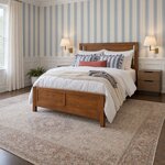 Diagonal angled room view showing the left side of a modern panel bed with a panel headboard, in a blue-striped bedroom.