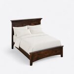 High angled view of a classic panel bed, looking down on the crowned three-panel headboard, side rails and low footboard.