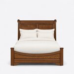 Front view of a traditional sleigh bed, showing a tall rolled headboard with recessed panels and a low U-shaped footboard.
