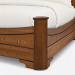 Footboard close-up of a traditional sleigh bed, showing a capped square corner post, the curved top rail and a bracket foot.