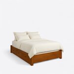 Diagonal angled view showing the right side of a modern platform bed, with three side drawers and a low solid footboard.